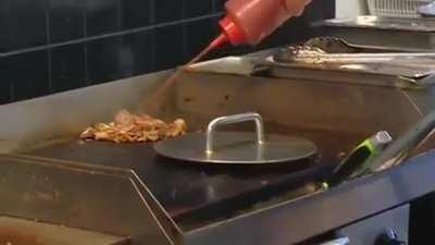 Shop owner ignoring a armed robber to finish helping a customer