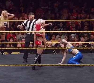 Alexa Bliss yanks the hair of Nikki Cross with a smile and crouches down to yell in her face “Welcome to NXT Nikki!”