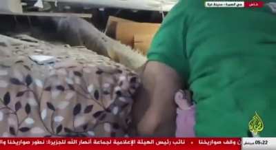 the rescue of an infant girl from the rubble of her home, which was destroyed by Israeli aircraft in Gaza City.