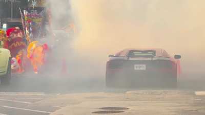 Fireworks going off in the middle of a busy parking lot
