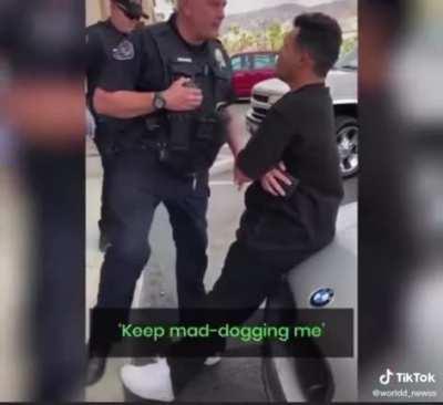 Police officer “detains” guy after getting in his face