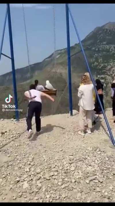 WCGW pushing a swing that’s on the edge of a cliff