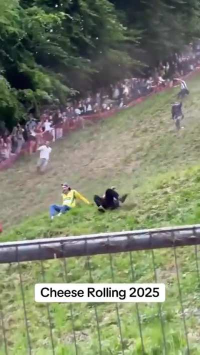A crazy angle of a man falling down the hill at the Gloucester cheese rolling competition in the UK.