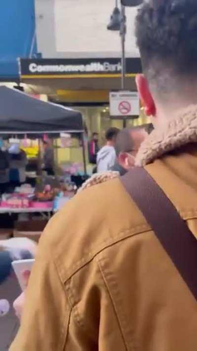 Drew Pavlou held a sign saying 