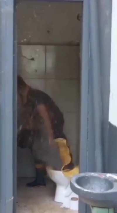 Trying to unclog the toilet with a pressure device.