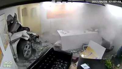 Car crashes through wall
