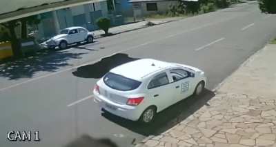 Truck opens up a sinkhole in the middle of the road.