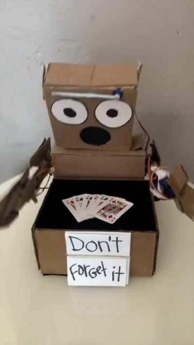 Remember that cardboard robot that does magic? He's back with a card trick!