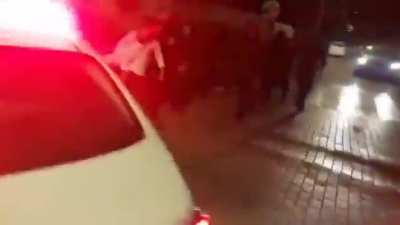 Outside an Israeli synagogue, hundreds of young religious men hurl abuse, spit, and trash at a woman for attending joint Israeli-Palestinian memorial ceremony