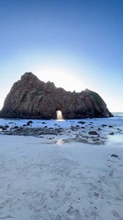 Waves crashing through Keyhole Arch, California