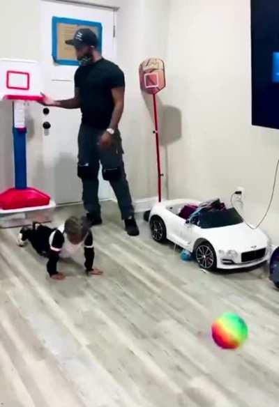 Dad Blocks toddler from shooting a basket and toddler isn’t having any of it