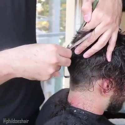 Watch as a toupee is applied.