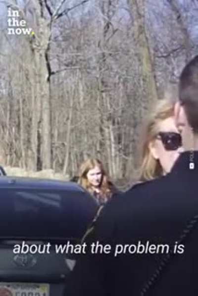 Commissioner Karen tries to argue with a police officer.