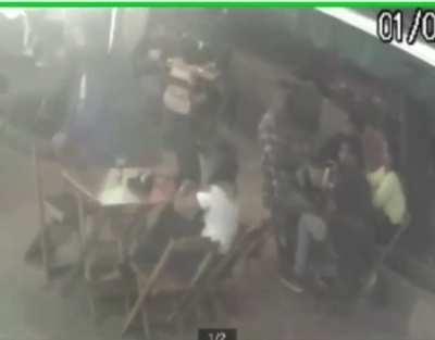 A man hits a woman at the bar and takes change from 4 men who were at the next table.