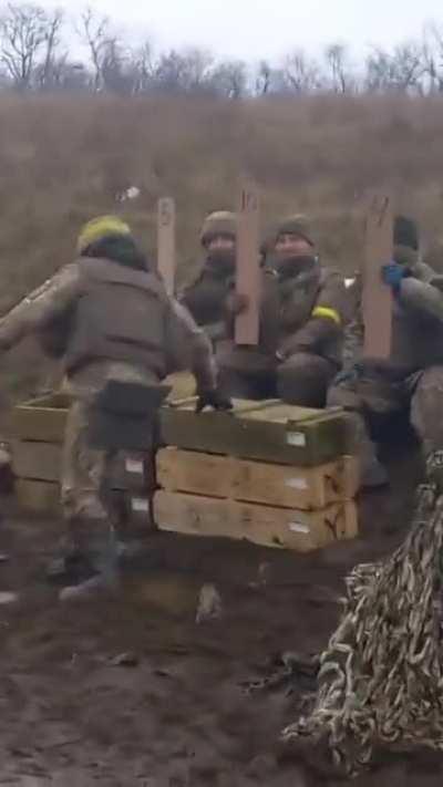 Ukrainian artillerymen fire a US-made M101 105mm howitzer as their brothers-in-arms nearby play the jury. Morale is high :)
