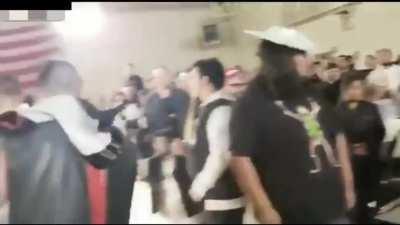 Wrestler spits gum on a kid