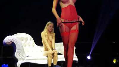 Stripperin strips a Girl on Stage in Front of a audience