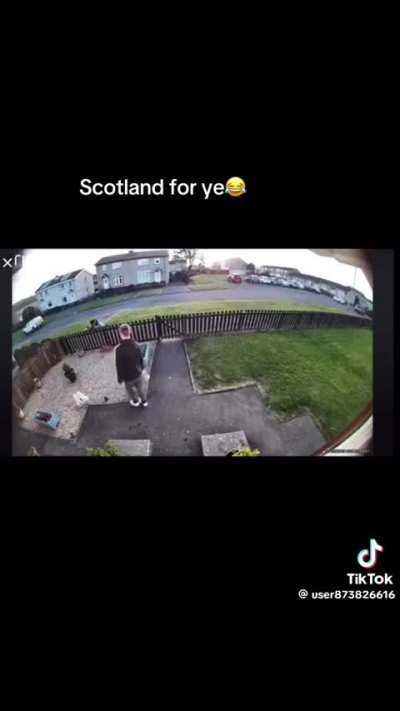 Scottish women fight in front of house, Man decides this is the perfect time to water plants.