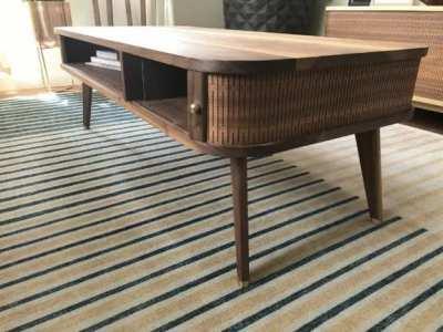 I designed and built a mid century style coffee table with a cnc kerf cut “tambour” door. It was also my first time having custom brass hardware made for the feet, which turned out nice.