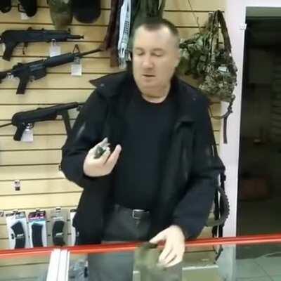 Russian man showing how to use a Grenade 