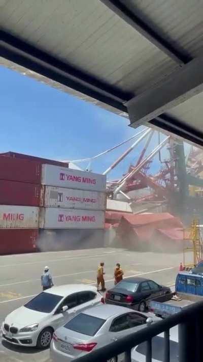 Crane collapses near containers