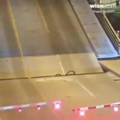 Bicyclist rides into void of a drawbridge as it's opening