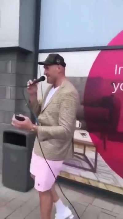 Tyson Fury joins street performer and sings 