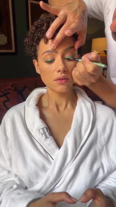 Getting her hair and makeup done 