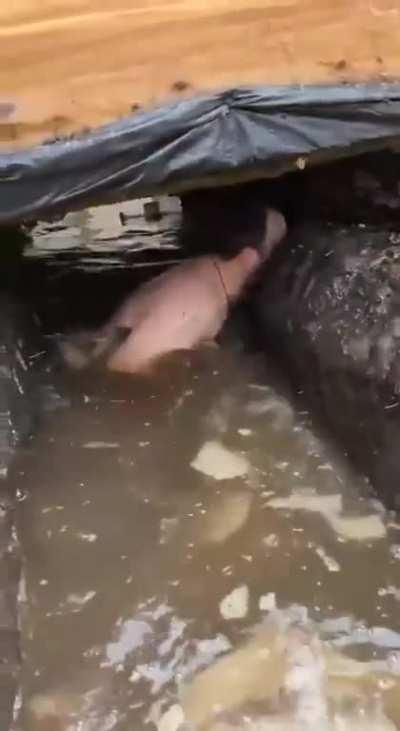 Rescuing ammo from a flooded trench in wintertime - it's a dirty job, but somebody's gotta do it.