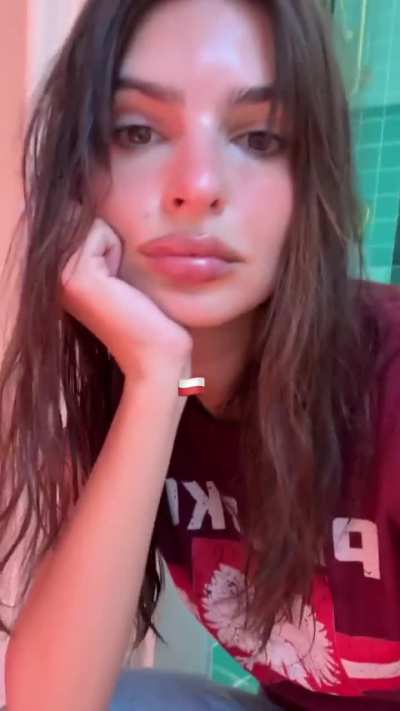 Emily in red tee and with her dog - IG May 2025