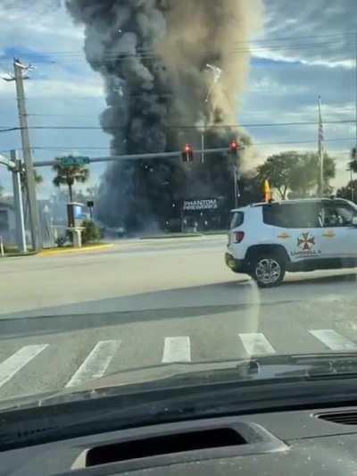 Fireworks store erupts in flames after car crashes into it.