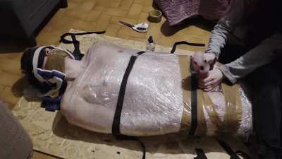 @00:23 Handjob with sextoy mummified in plastic foil post orgasm torment for 4 minutes long !