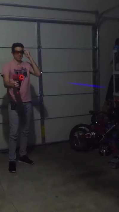 Using a rolling shutter on a laser beam to create a blaster effect