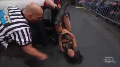 Gail Kim applies a figure four leg lock on Madison Rayne, then strikes a pose