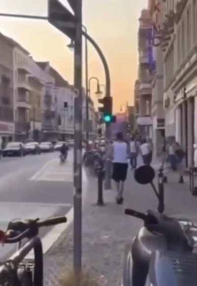 Man pushing two cyclists and running away