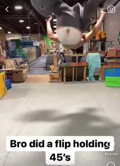 This guy did a flip while carrying two 45 pound weights 🤯