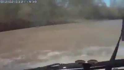 Russian truck drivers aren’t fazed at all when they crash into a river