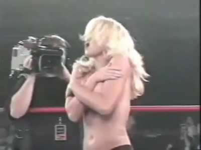 Getting her top removed during a wrestling match