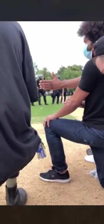 Peaceful protestor trying to keep the peace, gets silenced instead