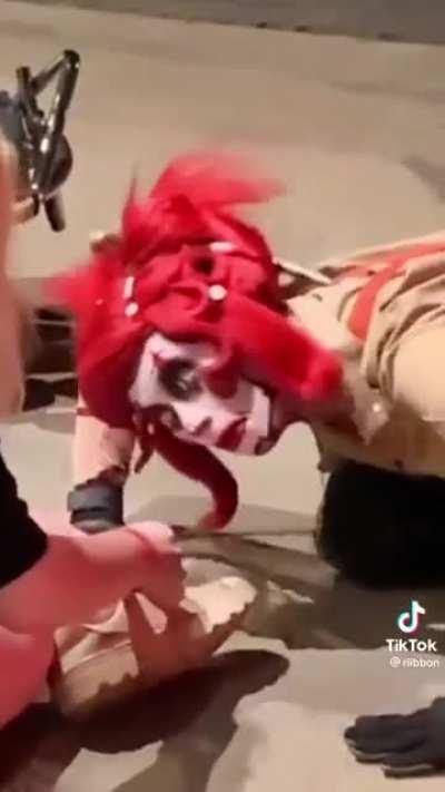 A clowns giving a nice shoe tying lesson
