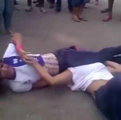 She grins & giggles while her opponent struggles between her thighs