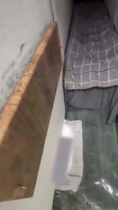 In China, 40 cm-wide “mini-end” units are rented for just one dollar, offering only a tiny bed, a power outlet, and a wall-mounted TV.