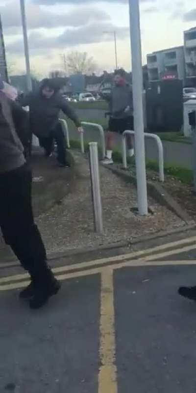 Two men fight with machetes in the middle of the road. Romford, UK.