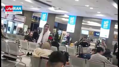 Woman in Iran takes off a mullah's turban and uses it to cover her hair after being harassed by him over not wearing the hijab