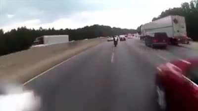Bikes pass between cars in traffic