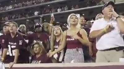A college football kicker's family watches and support him as he kicks the game-winning field goal.