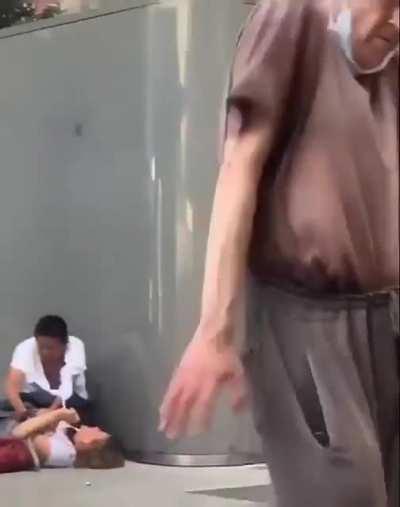 A woman is being mugged and this mentally ill homeless is dancing.