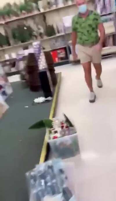 Man follows a woman throughout a store, demands she put her mask on.