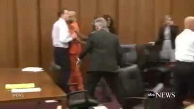 Dad Jumps Over Table To Attack Daughter's Killer in Court