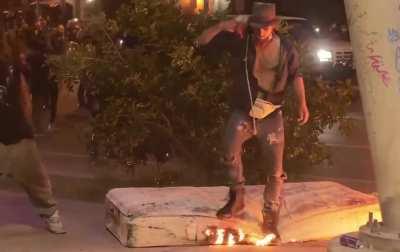 Homeless man’s possessions lit on fire by mob riot